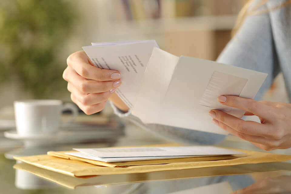  A woman opening an envelope