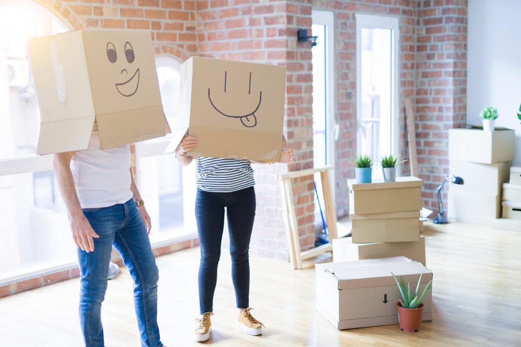 Man and woman with boxes over their heads, waiting for movers in San Francisco